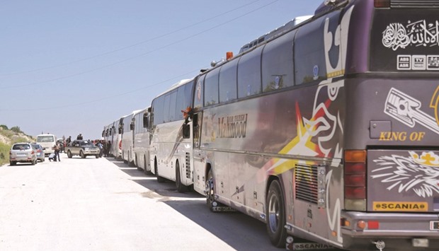 Buses line up on the outskirts of Idlib city, preparing to enter the two besieged towns of Fuaa and Kafraya to evacuate people yesterday.