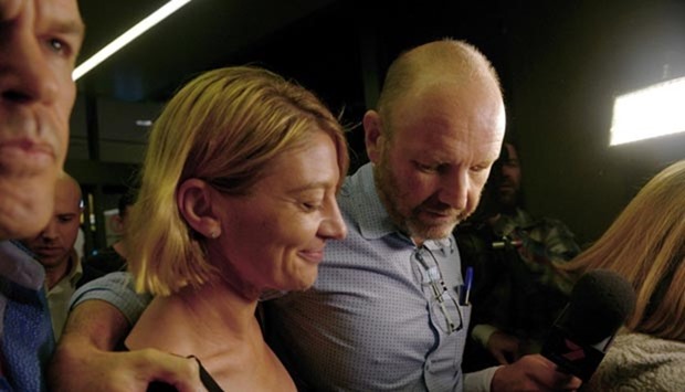 Australian TV presenter Tara Brown and producer Stephen Rice walk through Sydney airport on Thursday after they were released on bail from prison in Beirut.