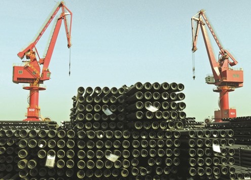 Cranes are seen above piles of steel pipes to be exported at a port in Jiangsu province. Chinese steel prices have risen by 77% so far this year, as supplies tightened following plant shutdowns last year, consumers restocked and seasonal demand picked up.
