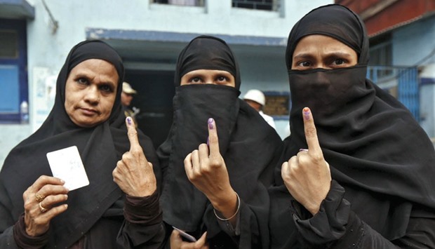 Women display their inked fingers after casting their votes during the third phase of West Bengal Assembly elections in Kolkata yesterday.