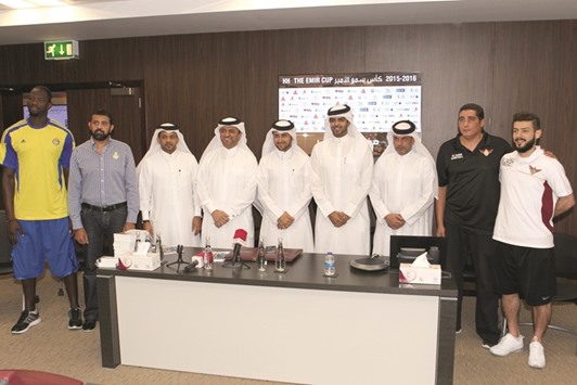 Players and officials of El Jaish and Al Gharafa clubs pose ahead of the Emir Cup final at the Qatar Basketball Federation headquarters.