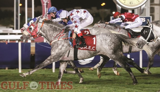 Jockey Marco Monteriso (in blue) rides Al Majhu2019Hoor to victory in the Al Huwaila Cup ahead of AJS Al Rayyan, ridden by Pier Convertino (foreground), at the Qatar Racing and Equestrian Club (QREC) here yesterday. PICTURES: Juhaim