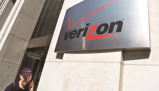 A pedestrian talks on his cell phone while walking past the Verizon Communications  headquarters in New York. Bonds of Verizon logged the highest gain among investment-grade companies, returning about 7.3%, according to Bank of America data.