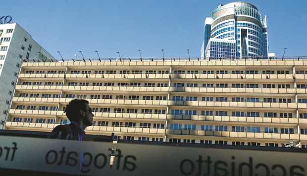 A pedestrian looks up towards the headquarters of Orange Polska (right) in Warsaw. Orange has abandoned its attempt to buy the phone business of Bouygues, denying the French phone industry a much-sought consolidation that would have eased competition in one of Europeu2019s toughest markets.