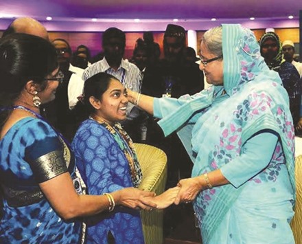 Prime Minister Sheikh Hasina talking to a girl after she addressed a function to mark World Autism Awareness Day yesterday in Dhaka.