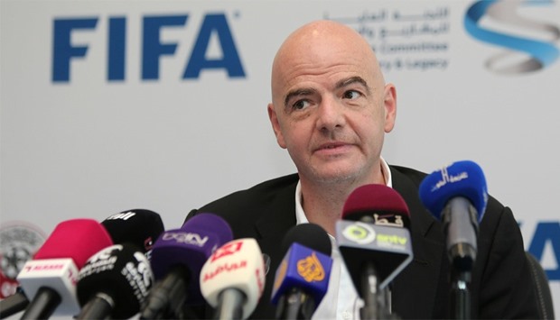 FIFA President Gianni Infantino listens to journalists' questions during a press conference in Doha