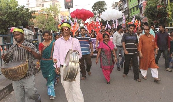 CPM candidate Ashok Bhattacharya is accompanied by party supporters as he campaigns for elections in Siliguri, West Bengal.