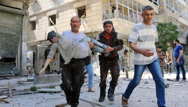 Syrian civil defence volunteers evacuate wounded people following a reported air strike in Aleppo on Friday.