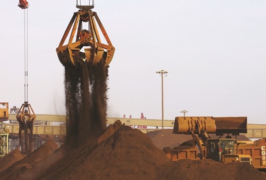 Cranes unload imported iron ore from a ship at a port in Rizhao, China. Iron ore prices have staged a surprise rally in 2016 as steelmakers in China revived output to a record last month.