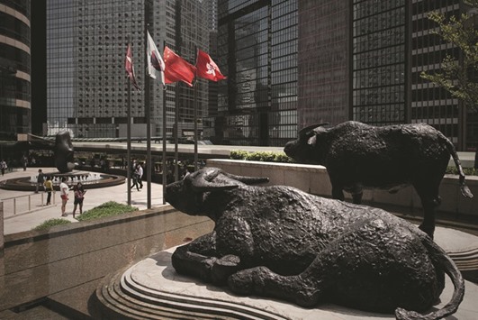 Two bull statues displayed outside the Hong Kong Stock Exchange. For all the gloom enveloping Hong Kong, the stock market is looking decidedly upbeat.