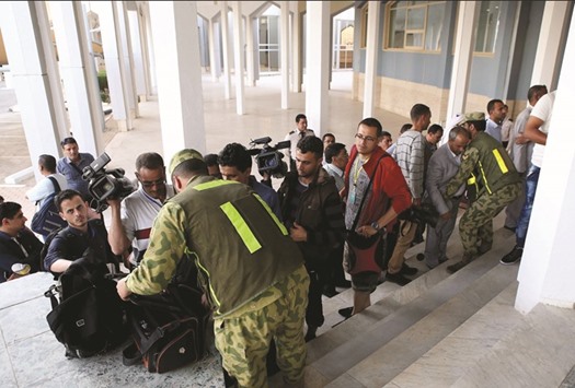 Yemeni journalists are checked by Kuwaiti security as they arrive at the Yemen peace talks media centre at the information ministry in Kuwait City yesterday.