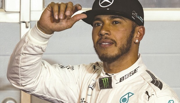 Mercedes AMG Petronas F1 Teamu2019s British driver Lewis Hamilton salutes after securing the pole position in the Bahrain Formula One Grand Prix after the qualifying session at the Sakhir circuit in Manama, a day ahead of the race. (AFP)