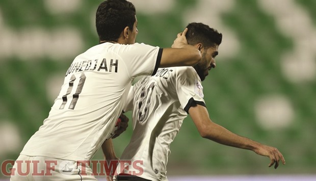 Al Saddu2019s Hassan al-Haydos is congratulated by Baghdad Bounedjah after he scored the first goal for his side against Al Sailiya yesterday.