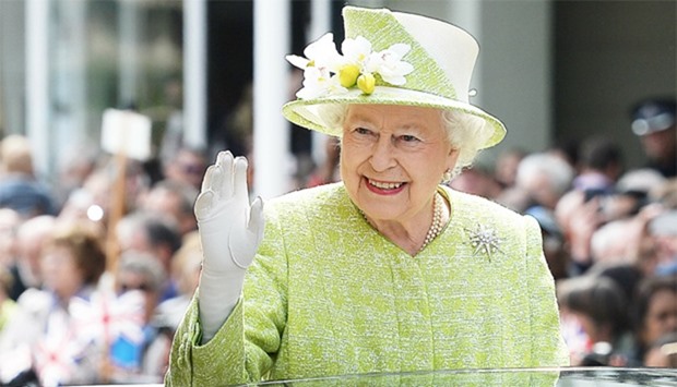 Britain's Queen Elizabeth II waves to wellwishers during a 'walkabout' on her 90th birthday