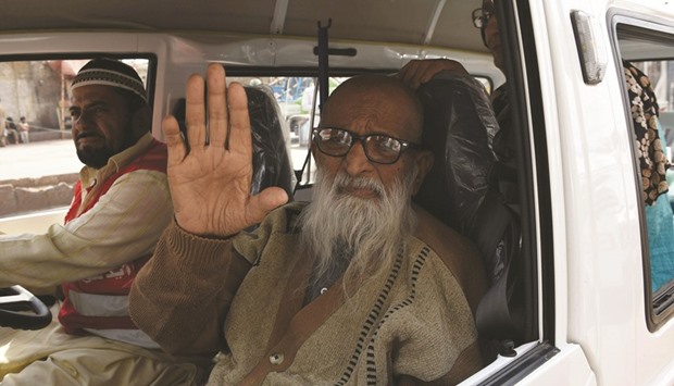Abdul Sattar Edhi, the head of Edhi Foundation, waves as he travels to his office in the port city of Karachi.