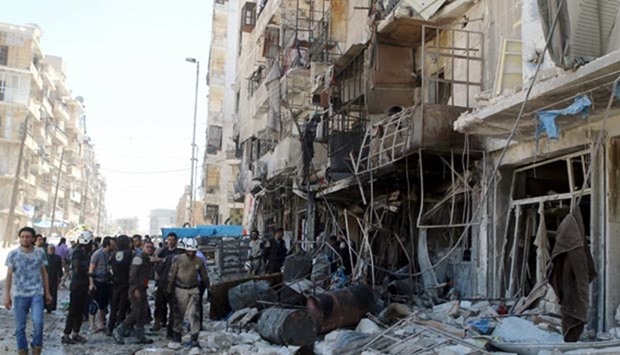 Residents and civil defence members inspect a damaged building after an airstrike on the rebel-held Tariq al-Bab neighbourhood of Aleppo on Saturday.