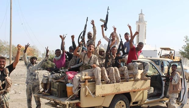 Forces loyal to Yemeni president flash their arms at a road on the entrance to Abyan province as they take part in an operation to drive al Qaeda fighters out of the southern provincial capital on Saturday.
