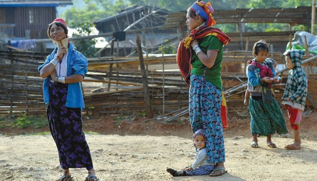 A recent photo shows Kayan tribeswomen wearing a stack of bronze neck coils u2014the statuesque sign of beauty of her Kayan tribe u2014 and children gathering at Panpet village located in Demoso township in Kayah state, central Myanmar.