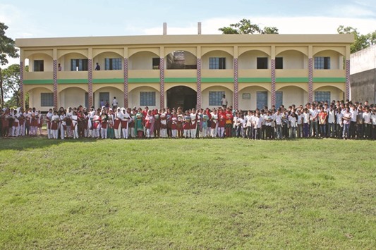 Students pose in front of the newly opened school in Haji Gong Bazar, 230km from Dhaka.