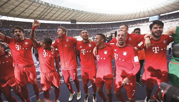 Bayern Munichu2019s players celebrate victory over Hertha Berlin in Berlin yesterday. (Reuters)