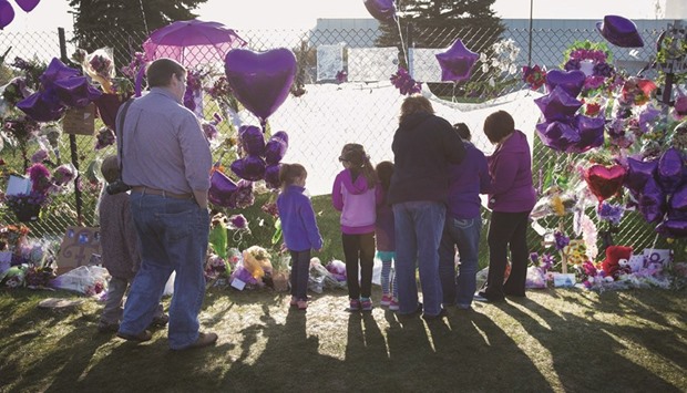 Music fans visit a memorial created outside Paisley Park, the home and studio of Prince, in Chanhassen, Minnesota.