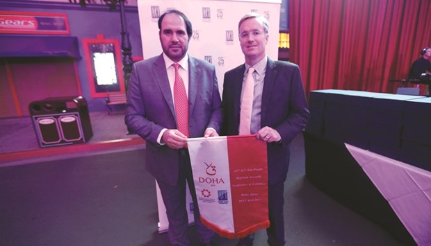 The u201chosting honouru201d being handed over to HIA at the 11th ACI Asia Pacific Regional Assembly, Conference and Exhibition, hosted at the Gold Coast, Australia by Chris Mills, CEO of Queensland Airports to Abdulaziz al- Mass, vice-president (Commercial and Marketing) at HIA (left).