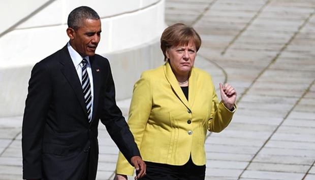 President Barack Obama and Chancellor Angela Merkel walk during a welcoming ceremony at the Herrenhausen Palace in Hanover on Sunday.