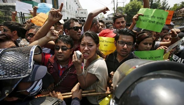 Police try to stop protesters during a demonstration against the Nepal government for the delay on reconstruction and relief during the first anniversary of the 2015 earthquake in Kathmandu on Sunday.