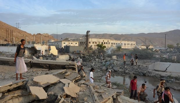 People inspect damage in Mukalla in southern Yemen on Sunday.