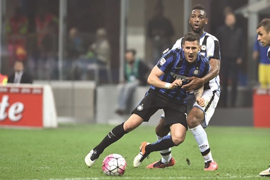Inter Milanu2019s Stevan Jovetic (left) fights for the ball with Udineseu2019s defender Molla Wague during the Italian Serie A at the San Siro Stadium in Milan. Inter won 3-1. (AFP)