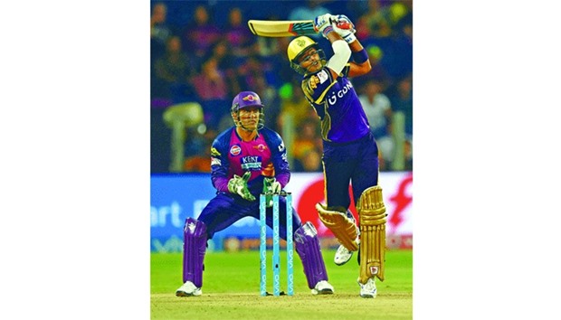 Kolkata Knight Riders batsman Suryakumar Yadav hits a boundary as Rising Pune Supergiants captain Mahendra Singh Dhoni looks on during their IPL clash in Pune yesterday. Yadav, who was adjudged the man-of-the-match, top-scored for his side with a 49-ball 60. (AFP)