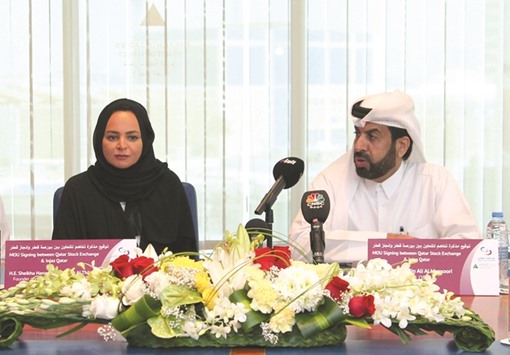 Sheikha Hanadi and al-Mansoori after signing the pact. The MoU aims to allow youth and students to join training programmes and courses held by the QSE in investment and financial culture.