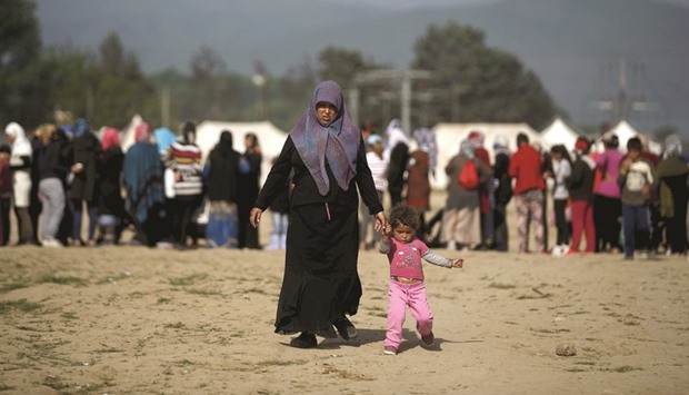 A woman and a girl walking at a makeshift camp for migrants and refugees at the Greek-Macedonian border near the village of Idomeni, Greece. The new set of global targets, the Sustainable Development Goals (SDGs), aim to build on  progress achieved in the earlier Millennium Development Goals (MDGs) initiative from 2000 to 2015, not only in eradicating poverty, but also in addressing a number of other challenges, such as broadening access to education and protecting the environment. But, this time, there are significant headwinds. Recent geopolitical developments, such as the Middle Eastu2019s refugee crisis, are complicating government budgets and agendas.