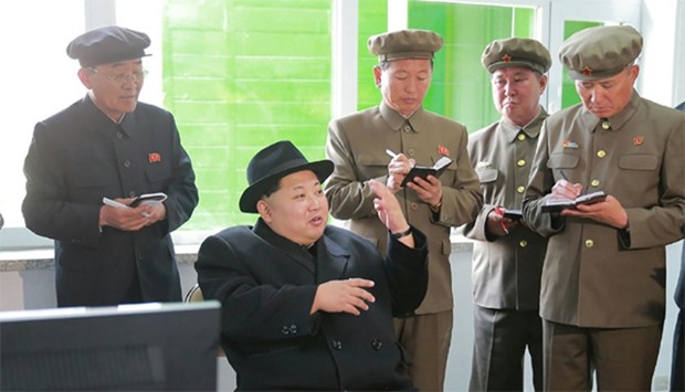 North Korean leader Kim Jong-Un (C) at the Paektusan Hero Youth Power Station
