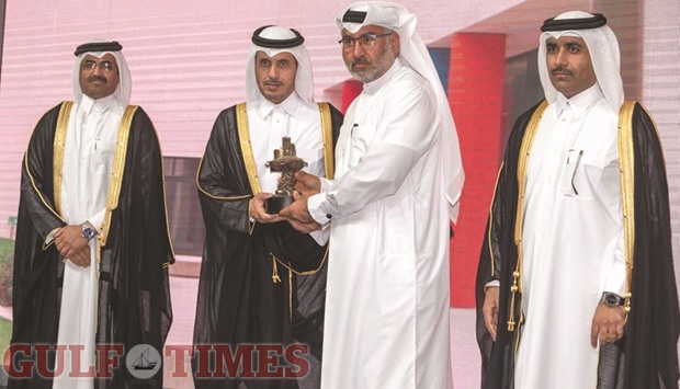 HE the Prime Minister and Interior Minister Sheikh Abdullah bin Nasser bin Khalifa al-Thani honouring Msheireb Properties CEO Abdulla al-Mehshadi as HE the Minister of Energy and Industry Dr Mohamed bin Saleh al-Sada and Kahramaa president Essa bin Hilal al-Kuwari look on.
