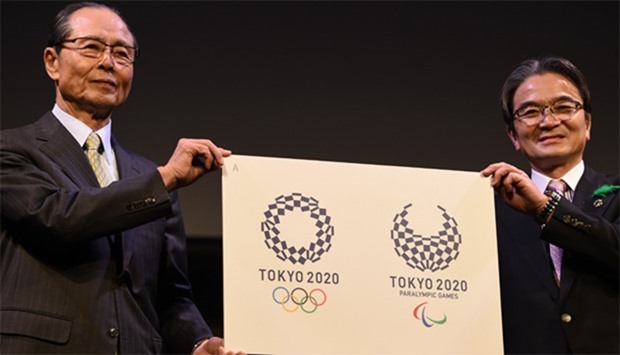 Ryohei Miyata, Tokyo 2020 emblems selection committee chairperson (R) and committee member and former baseball star Sadaharu Oh (L) present the newly-selected Tokyo 2020 logo