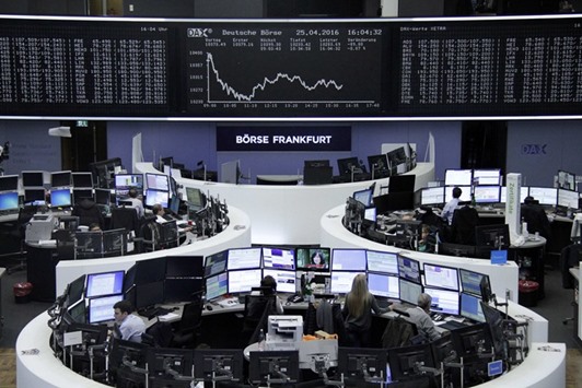 Traders work at the Frankfurt Stock Exchange. The DAX 30 lost 0.9% yesterday.