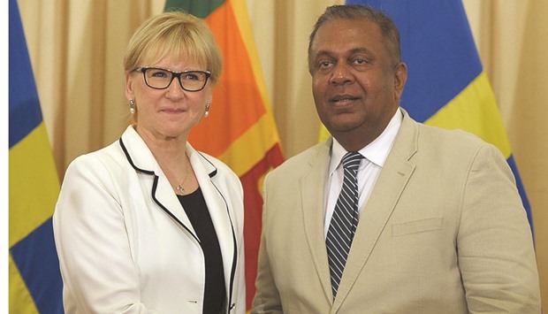 Sri Lankau2019s Foreign Minister Mangala Samaraweera, right, shaking hands with Swedish Foreign Minister Margot Wallstrom in Colombo yesterday.