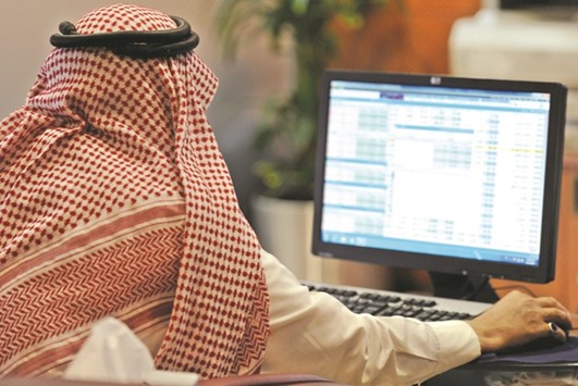 An investor monitors stock prices at the Saudi Stock Exchange. The bourse jumped 2.5% yesterday.