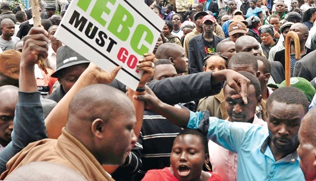 Kenyau2019s opposition supporters protest outside the headquarters of the Independent Electoral and Boundaries Commission (IEBC) in Nairobi yesterday.
