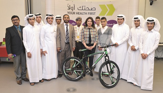 WCM-Q chief communications officer Nesreen al-Rifai (centre), with teachers and students from some of the winning schools.