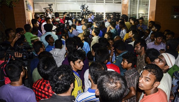 Bangladeshi journalists and onlookers where the activist was allegedly hacked to death
