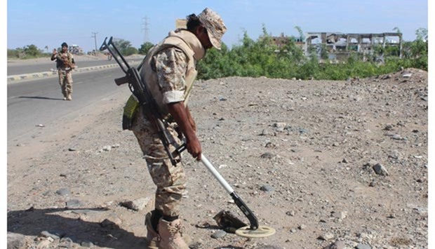 Forces loyal to the Saudi-backed Yemeni president search for improvised explosive devices (IED) as they patrol a road in the southern city of Lahj.