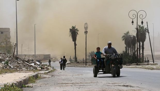 Syrians leave the Bab al-Nayrab neighbourhod in Aleppo on Tuesday.