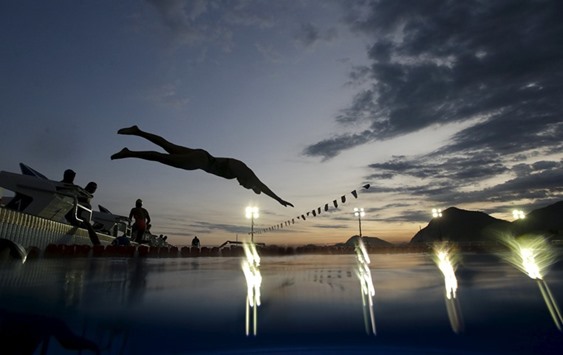 Erica Rodrigues of Brazil jumps into the warm up pool during an Olympics warm-up event in Rio de Janeiro.