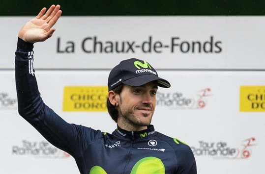 Spainu2019s Ion Izagirre of Team Movistar waves on the podium after winning the 3,95km prologue of the 70th Tour de Romandie cycling race in La Chaux-de-Fonds, Switzerland. (AFP)