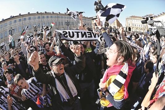Juventusu2019 supporters celebrate after their soccer club won the Italian Serie A in downtown Turin, Italy.