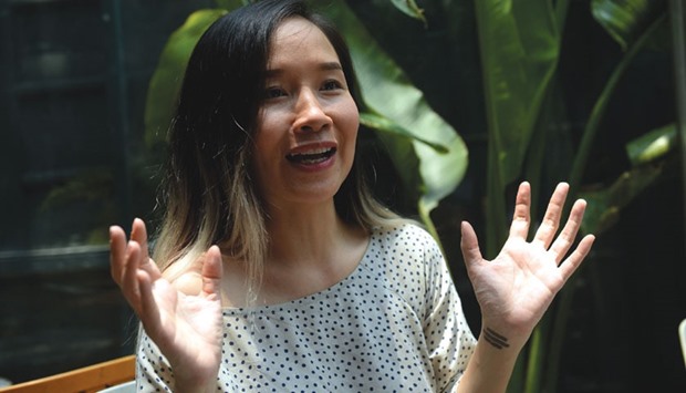 Singer Mai Khoi gesturing while talking during an interview in Hanoi.