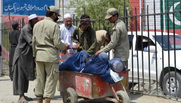 Pakistani border security personnel search an Afghan family entering Pakistan after crossing the Torkham Border in Pakistanu2019s Khyber Agency yesterday.