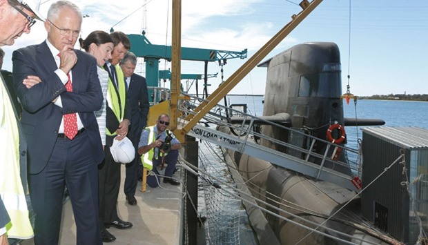 Australian Prime Minister Malcolm Turnbull (second left) looks at a Royal Australian Navy Collins-class submarine at the ASC naval shipyards in Adelaide yesterday.